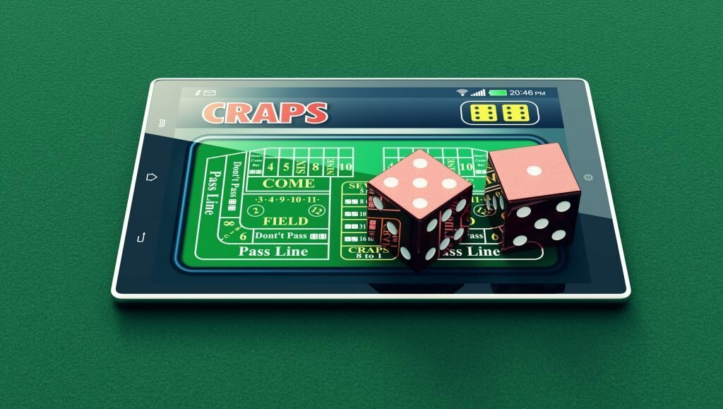 Dice sitting on tablet that is playing digital craps.