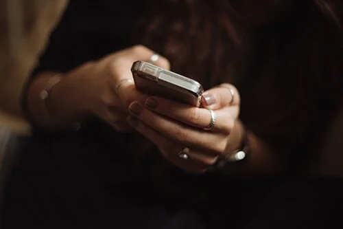 Person playing blackjack on their phone