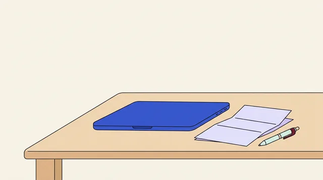 Folded contract and pen resting beside a closed laptop on a table